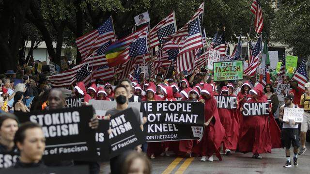 A large crowd marches though downtown street during the No Kings Rally in Fort Worth on Friday, Oct. 17, 2025.